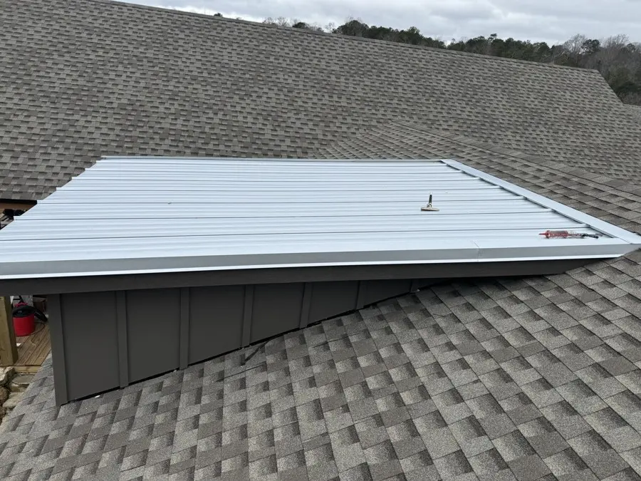 New roof on a house with a crew's truck parked nearby