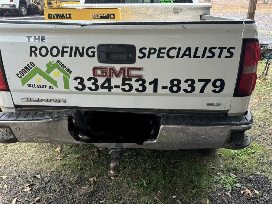 Work truck tailgate with the Correo Roofing name and phone number
